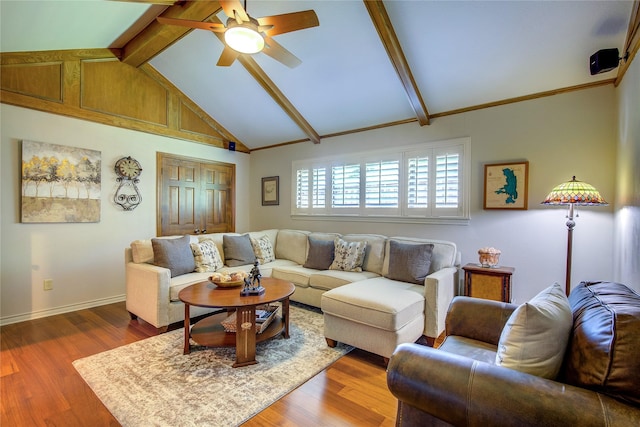 living room featuring wood finished floors, lofted ceiling with beams, a ceiling fan, and baseboards