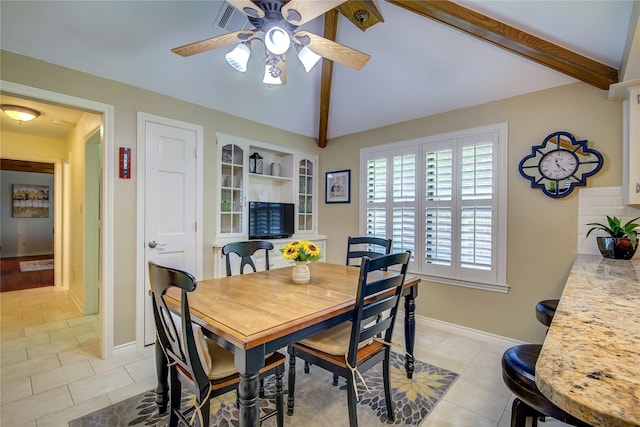 dining room featuring baseboards, vaulted ceiling with beams, a ceiling fan, and light tile patterned flooring