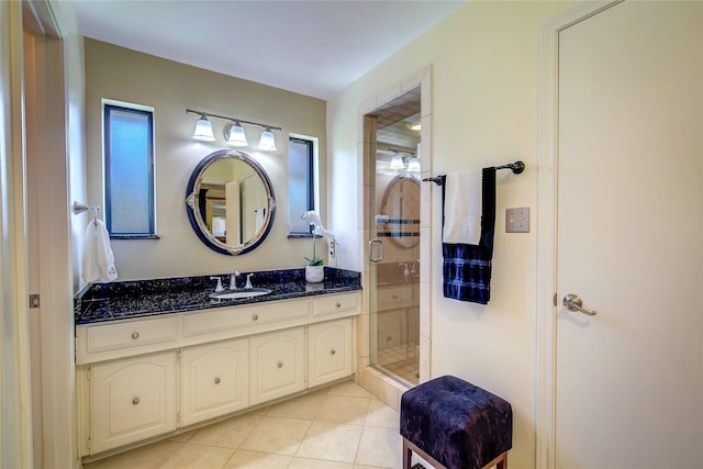 full bath with tile patterned floors, vanity, and a shower stall