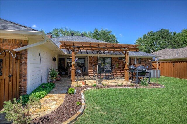 back of property featuring a chimney, a pergola, a patio area, central AC, and a lawn