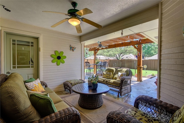 view of patio / terrace with fence, an outdoor hangout area, and a ceiling fan
