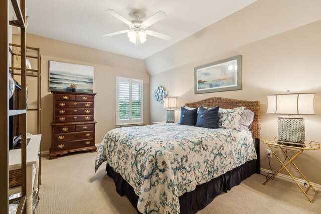 bedroom featuring ceiling fan, baseboards, vaulted ceiling, and light carpet