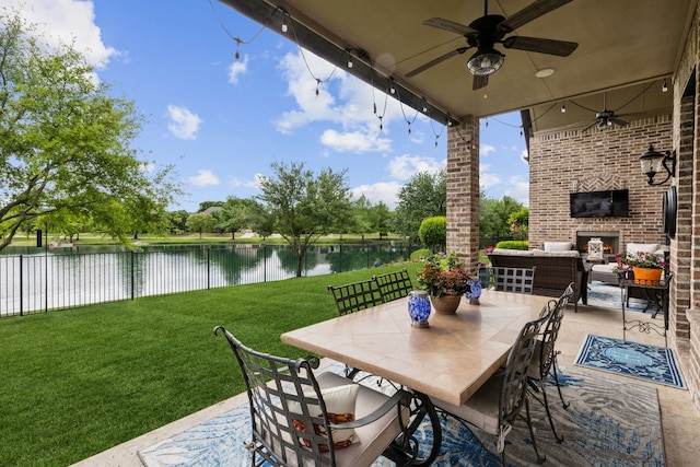 view of patio featuring fence, ceiling fan, and an outdoor living space with a fireplace