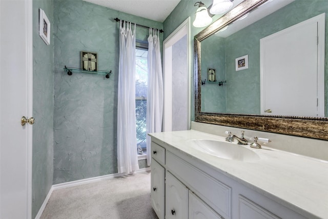 bathroom featuring vanity and baseboards