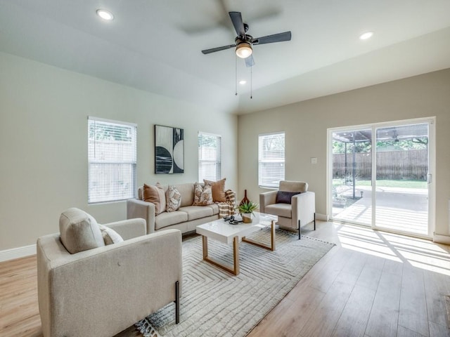 living room with ceiling fan, recessed lighting, and light wood-style floors