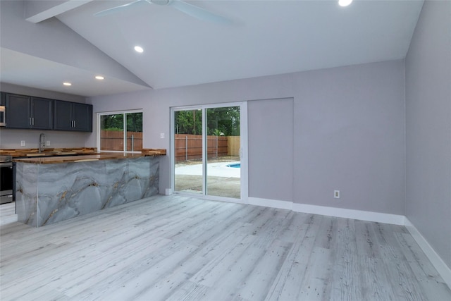 kitchen featuring lofted ceiling with beams, recessed lighting, light wood finished floors, a ceiling fan, and range