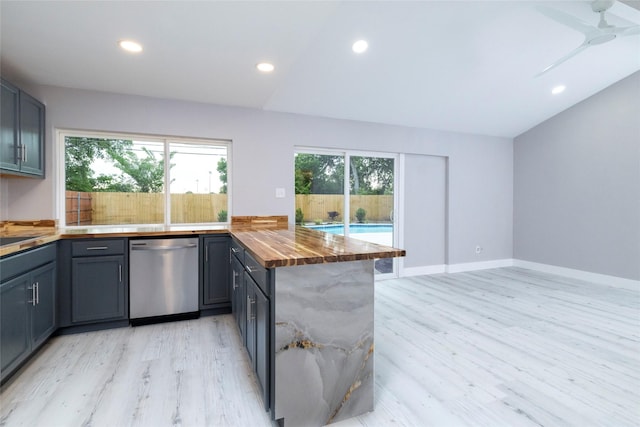 kitchen with dishwasher, wood counters, a peninsula, vaulted ceiling, and light wood-style floors