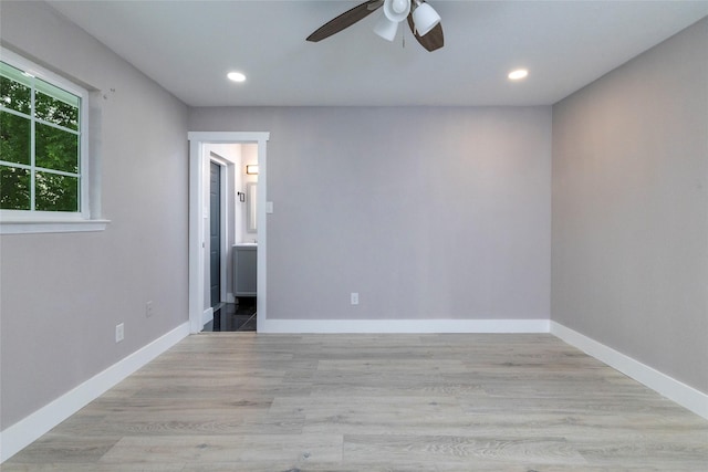 spare room with light wood-type flooring, baseboards, a ceiling fan, and recessed lighting