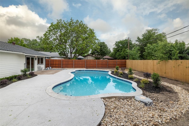 view of swimming pool with a patio area, a fenced in pool, and a fenced backyard