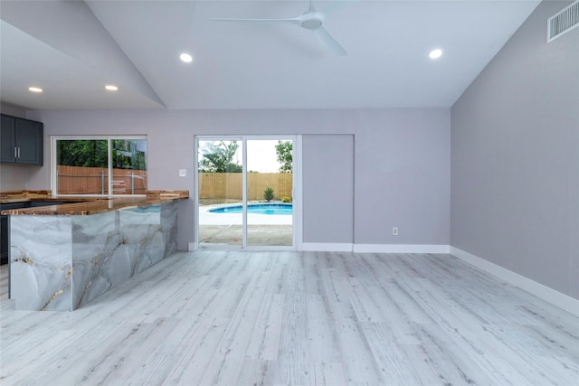 unfurnished living room featuring a healthy amount of sunlight, ceiling fan, light wood-type flooring, and visible vents