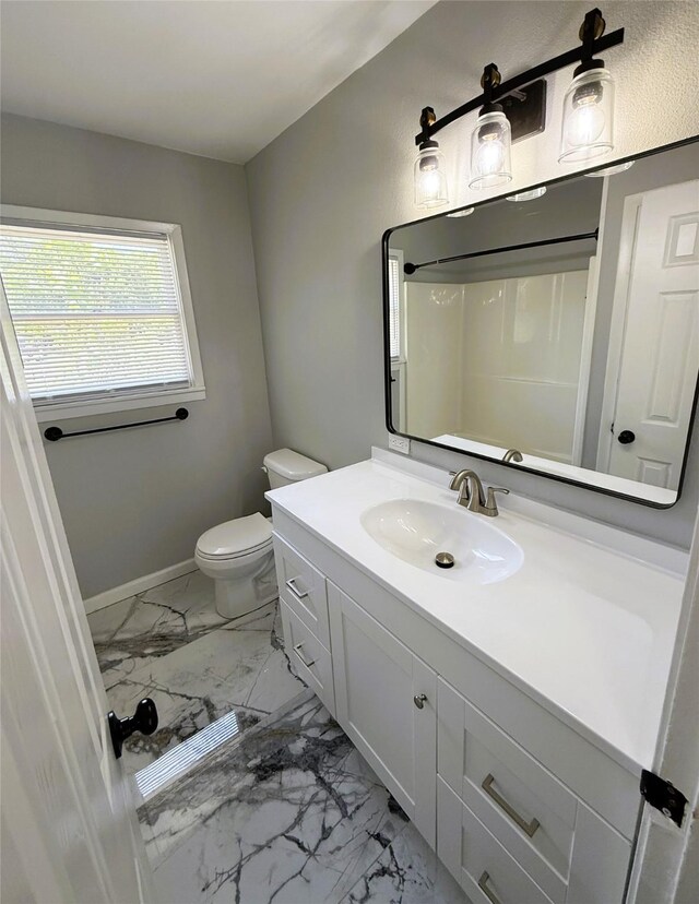 full bath with baseboards, toilet, vanity, and marble finish floor