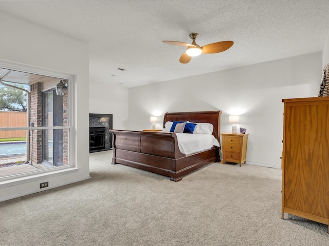 2024 Crestside Dr, Carrollton, TX 75007 - carpeted bedroom featuring a fireplace, a textured ceiling, a ceiling fan, and baseboards