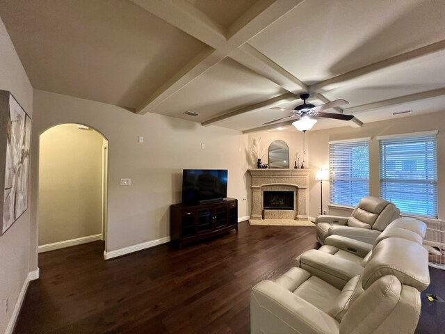 15100 Mount Evans Dr, Little Elm, TX 75068 - living area with arched walkways, dark wood-style floors, ceiling fan, a fireplace, and beam ceiling