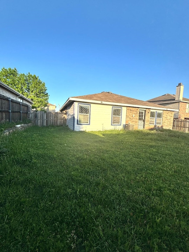 exterior space featuring fence and a yard