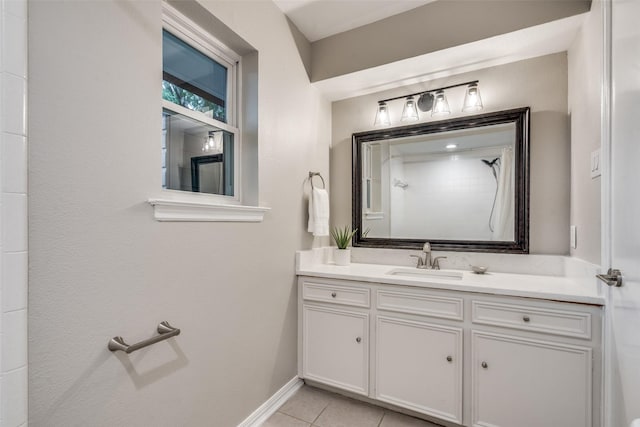 full bathroom featuring tile patterned floors, walk in shower, vanity, and baseboards
