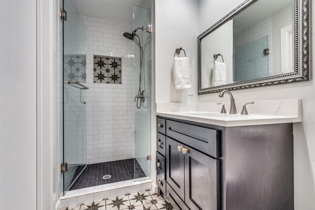 bathroom featuring a stall shower and vanity