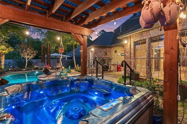 view of swimming pool with a fenced backyard, a hot tub, and a patio area