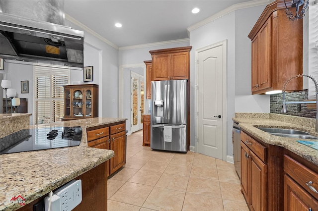 kitchen with light stone counters, ventilation hood, a sink, brown cabinetry, and stainless steel appliances