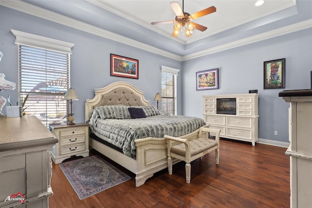 bedroom with a ceiling fan, crown molding, baseboards, dark wood-style floors, and a tray ceiling