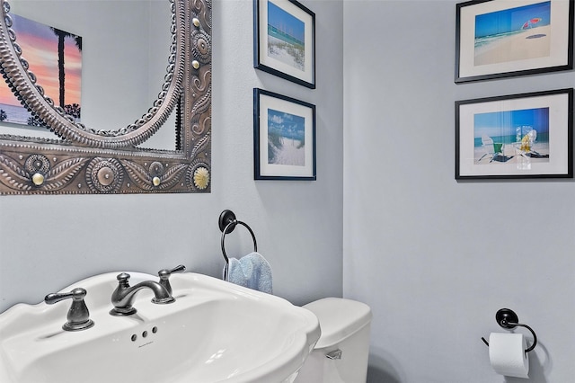 bathroom with toilet and a sink