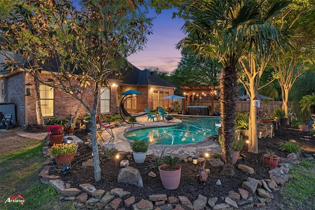 view of pool featuring a hot tub, a fenced in pool, a fenced backyard, and a patio area