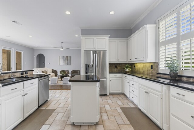 kitchen featuring a sink, stone tile floors, stainless steel appliances, backsplash, and visible vents