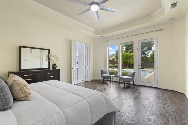 bedroom featuring crown molding, access to outside, a tray ceiling, and visible vents