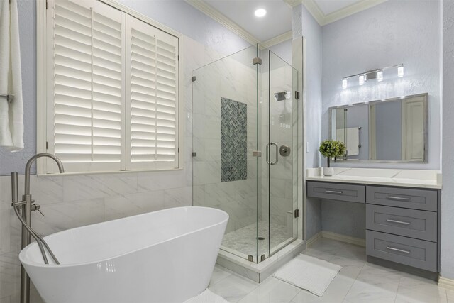 full bath featuring a freestanding bath, vanity, marble finish floor, a shower stall, and ornamental molding
