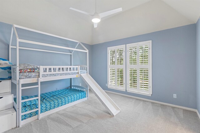 unfurnished bedroom with carpet floors, baseboards, ceiling fan, and lofted ceiling