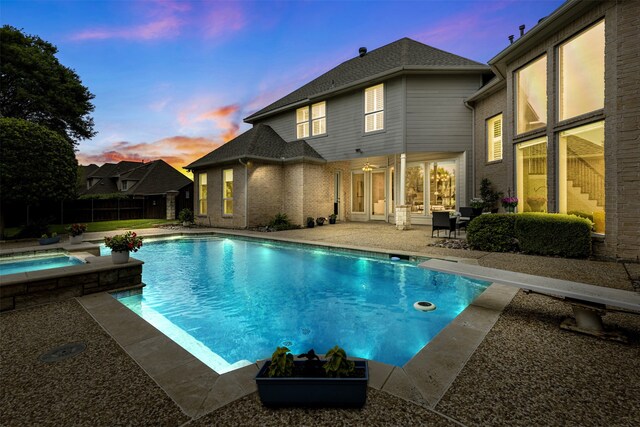 view of pool with fence, an in ground hot tub, a fenced in pool, and a patio area