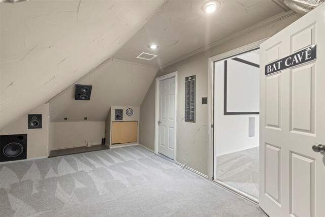 bonus room with baseboards, visible vents, light carpet, and lofted ceiling