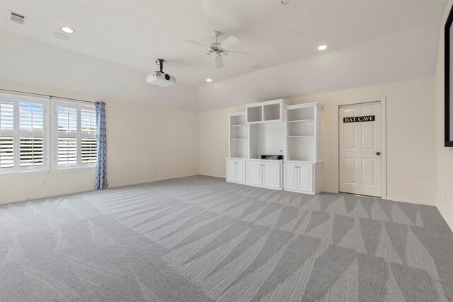 unfurnished room with light colored carpet, a ceiling fan, visible vents, and baseboards