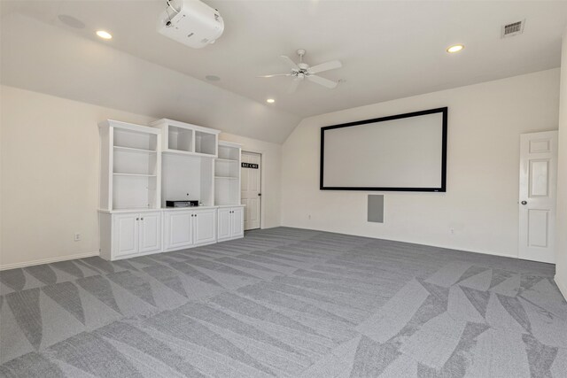 home theater featuring visible vents, ceiling fan, and light carpet