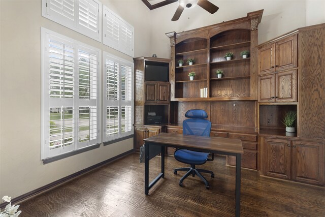 home office featuring baseboards, a ceiling fan, and dark wood finished floors