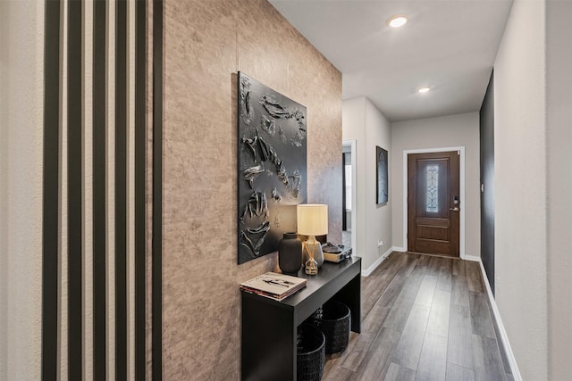 doorway to outside featuring baseboards, recessed lighting, and wood finished floors