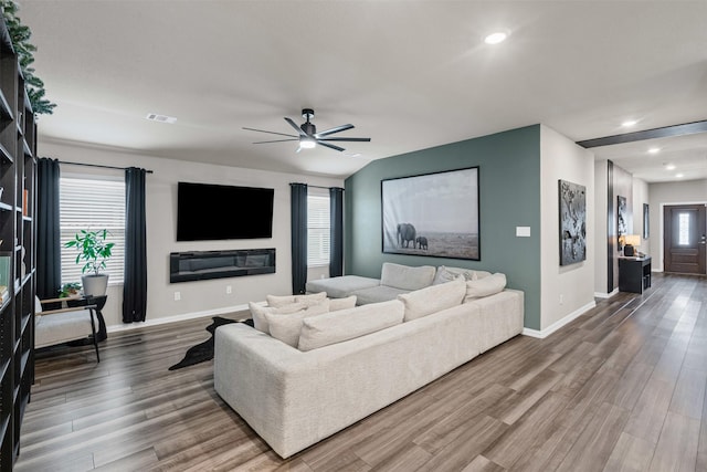 living area with visible vents, ceiling fan, baseboards, recessed lighting, and wood finished floors
