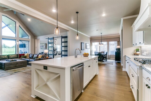 12492 Palmer Dr, Fort Worth, TX 76179 - kitchen featuring a sink, appliances with stainless steel finishes, light wood finished floors, and a barn door