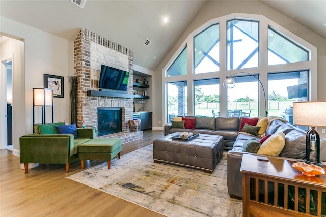 12492 Palmer Dr, Fort Worth, TX 76179 - living room featuring high vaulted ceiling, baseboards, wood finished floors, and visible vents