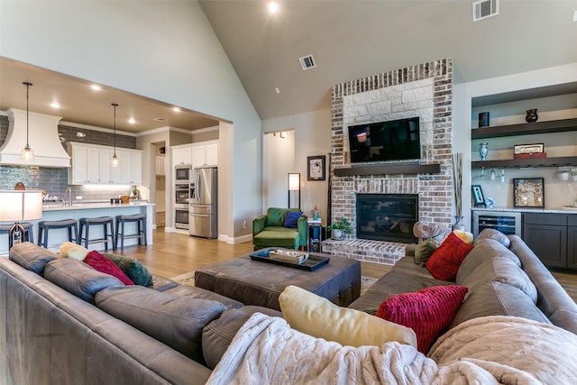 12492 Palmer Dr, Fort Worth, TX 76179 - living room featuring light wood-type flooring, visible vents, high vaulted ceiling, and indoor bar
