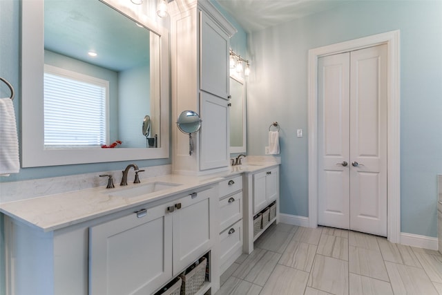 12492 Palmer Dr, Fort Worth, TX 76179 - bathroom with a sink, baseboards, and double vanity