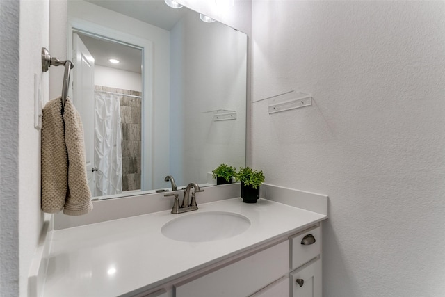 12492 Palmer Dr, Fort Worth, TX 76179 - bathroom with vanity, a textured wall, and tiled shower