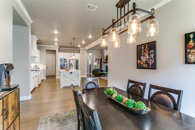 12492 Palmer Dr, Fort Worth, TX 76179 - dining room with recessed lighting, visible vents, ornamental molding, and light wood-type flooring
