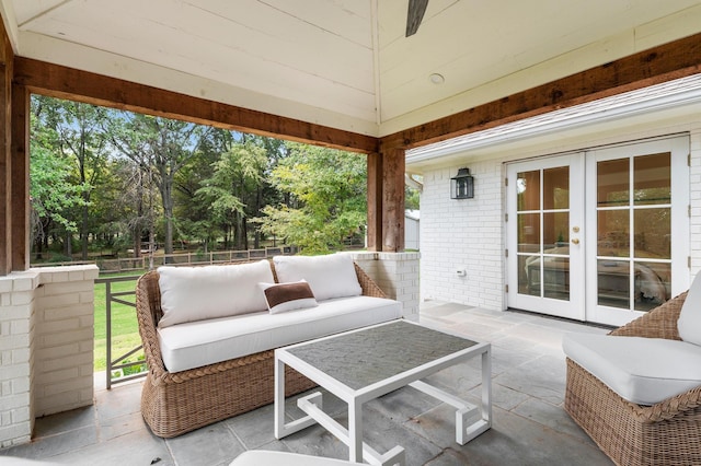 view of patio with outdoor lounge area, french doors, and fence