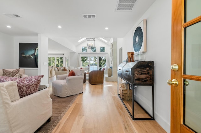 living area with light wood finished floors and visible vents