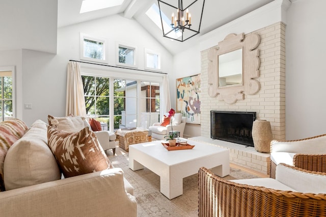 living room featuring beamed ceiling, a chandelier, a brick fireplace, high vaulted ceiling, and a skylight