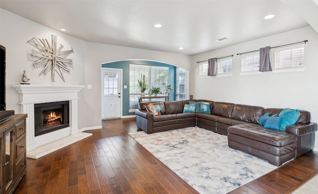 420 Westminster Dr, Lewisville, TX 75056 - living area with arched walkways, dark wood finished floors, recessed lighting, and visible vents