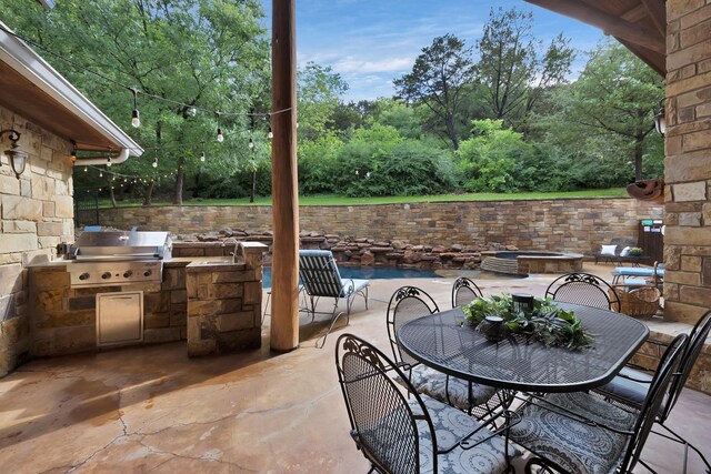 view of patio / terrace featuring an outdoor kitchen, outdoor dining space, and grilling area
