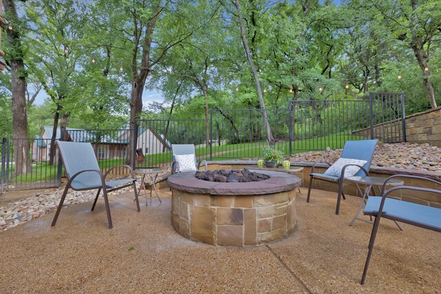 view of patio / terrace with fence and an outdoor fire pit