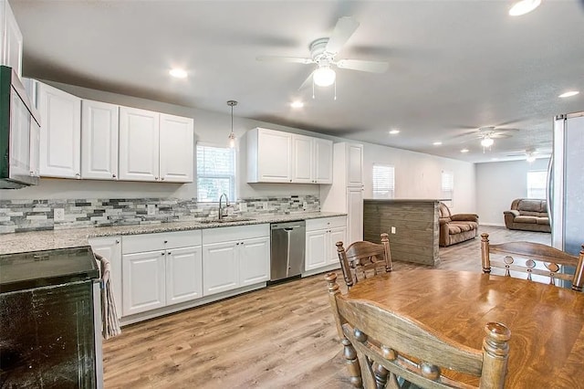 kitchen with white cabinetry, a sink, ceiling fan, stainless steel appliances, and light wood-style floors