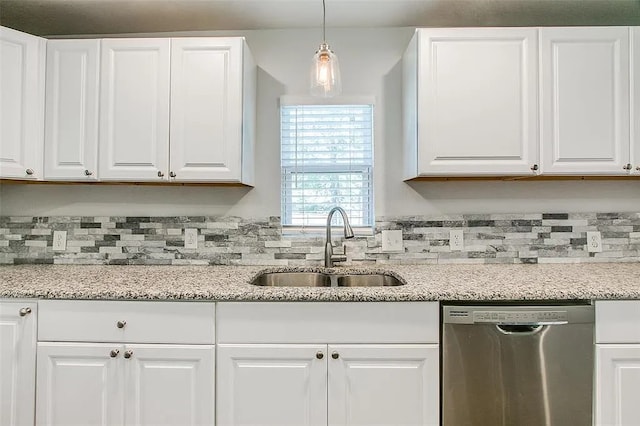 kitchen with pendant lighting, white cabinetry, a sink, light stone countertops, and dishwasher